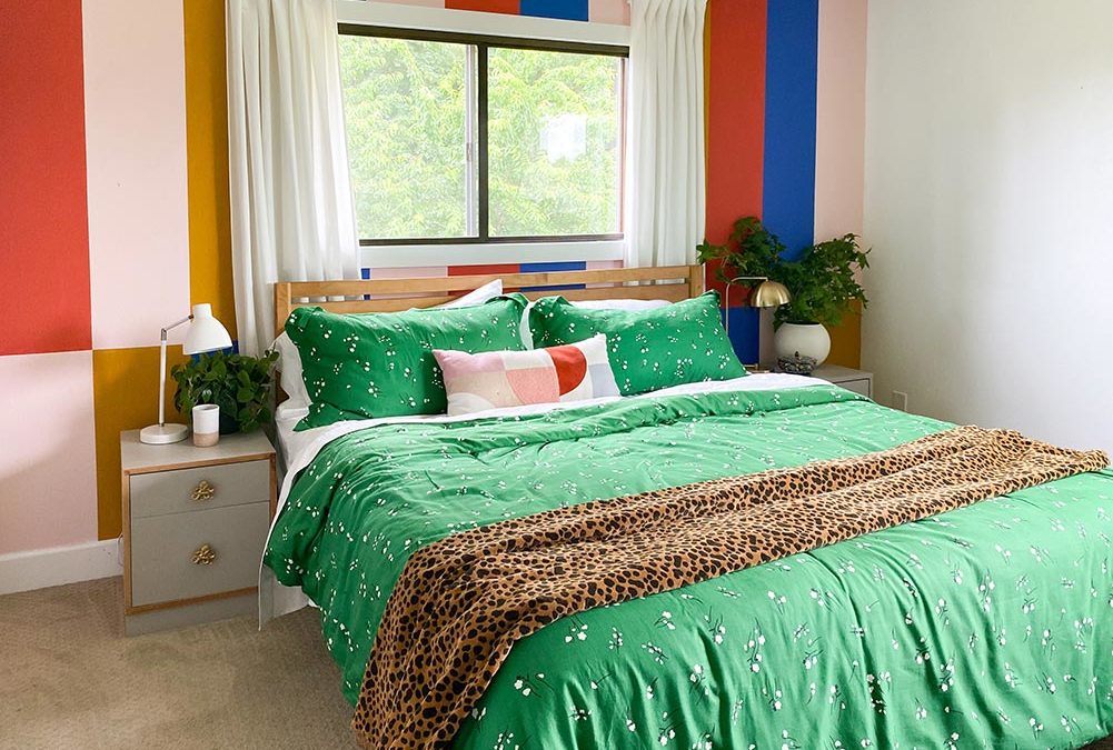 bold-colorful-striped-mural-behind-bed-with-rustoleum-spray-painted-upcycled-nightstands-by-banyan-bridges