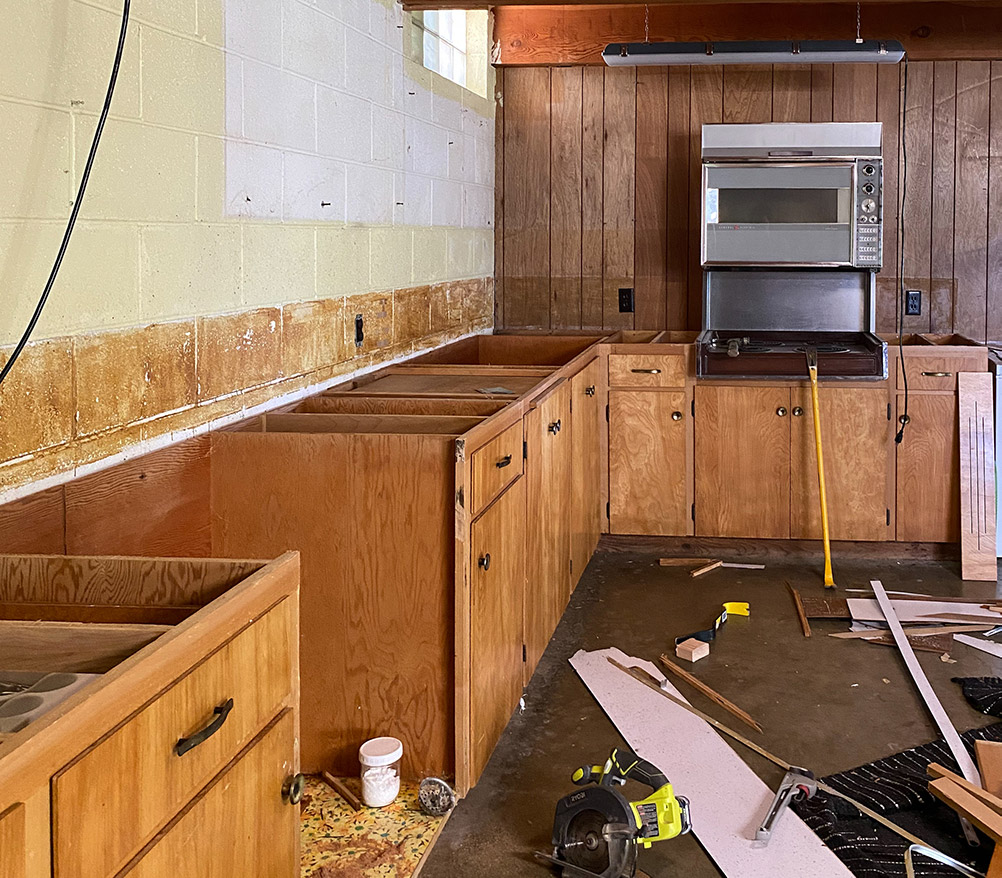 Lower cabinetry after demolition with no countertops or backsplash