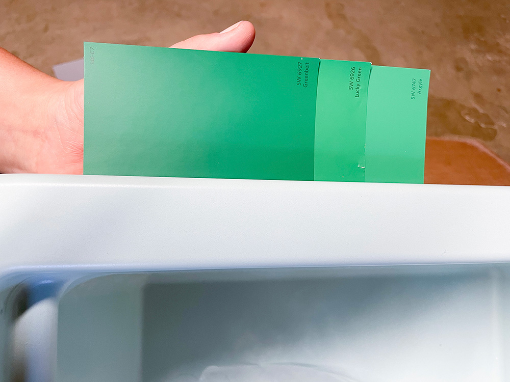 Three green swatches next to a mint green sink