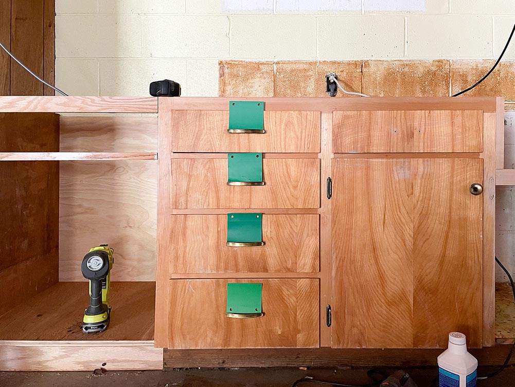 Old wood cabinetry with green swatches
