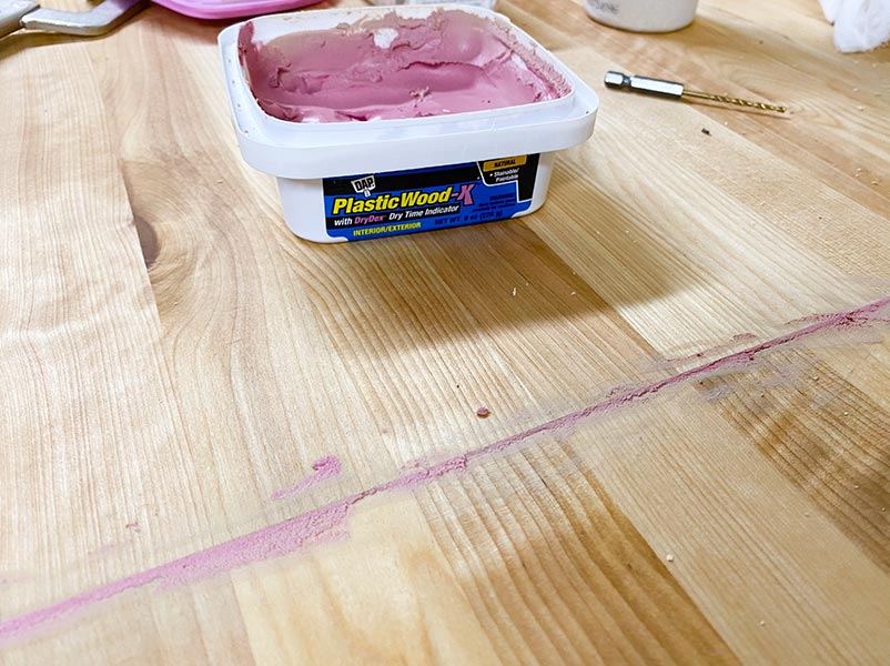 Wood putty applied to butcher block countertops that's not dry so it shows purple color