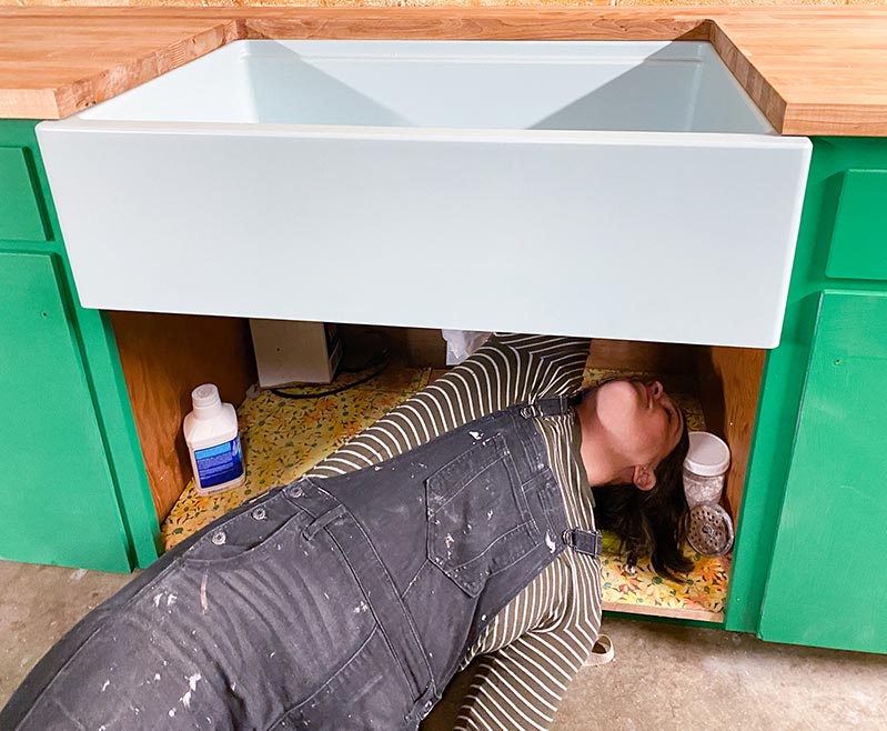 Racheal Jackson checking the dry fit of the Elkay mint sink in the green cabinets